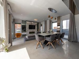 a dining room and living room with a table and chairs at Villa Nina in Croatia near the Adriatic Coast in Zaton