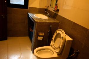 a bathroom with a toilet and a sink at Srijana Farm in Pālpā +44 photos