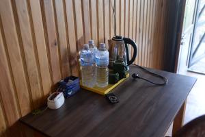 a wooden table with two bottles of water on it at Srijana Farm in Pālpā