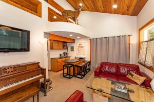 a living room with a couch and a piano at Cozy Cedar Cabin Near Silverwood Theme Park - Sleeps 5 - Quiet & Private in Spirit Lake +34 photos