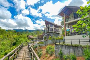 a house on a hill with stairs leading up to it at La Casa Lindula Villa Sarendip in Nuwara Eliya