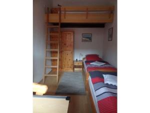 a bedroom with a bunk bed and a ladder at Eul K3 completely fenced in Großwürden