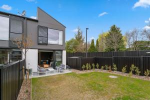 a modern house with a black fence at Mt Iron Vista in Wanaka
