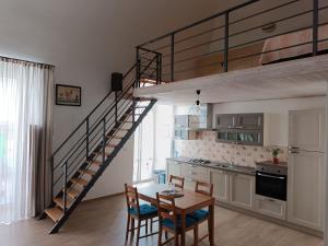 a kitchen and dining room with a spiral staircase in a apartment at B&B San Francesco in Molfetta
