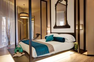 a bedroom with a bed with a mirror at Dharma Luxury Hotel in Rome