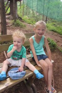 two young children sitting on a park bench at Appartements Hochzillertal in Kaltenbach