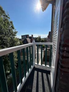 a balcony with a white railing on a house at Logement entier studio vue mer in Villers-sur-Mer