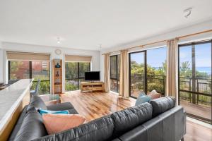 a living room with a couch and a television at Apartment 5 Pacific Apartments in Lorne