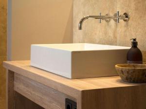 a white sink sitting on top of a counter at Oceans 18 Comfortable holiday residence in Wenningstedt +37 photos