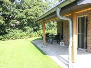awning over a patio with a table in a yard at Coastal House Wremen in Wremerbüttel