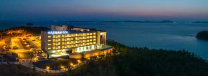 a view of a hotel at night next to the water at Haenam 126 Hotel in Haenam