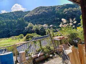 a balcony with a view of a mountain at プレオープンの旅人宿 in Shimanto