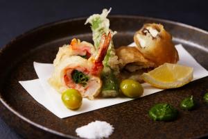 a plate of food with shrimp and vegetables and a lemon at JW Marriott Hotel Nara in Nara