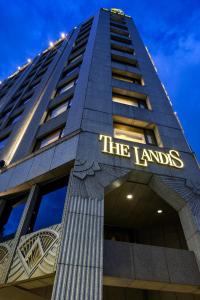 a tall building with a sign that reads the lumps at The Landis Taipei in Taipei