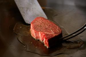 a piece of meat on a fork on a table at JW Marriott Hotel Nara in Nara +37 photos