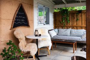 a patio with a couch and a table and chairs at Wellness Escape- Near Town & Beach- Sea La Vie in Margaret River Town