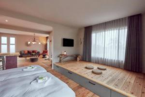 a bedroom with a large bed and a living room at Villa oloo in Karimata