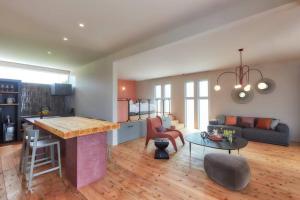 a kitchen and living room with a table and a couch at Villa oloo in Karimata
