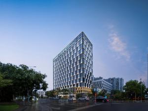 a tall building with a lot of windows at Atour Hotel Suzhou Wuzhong Taihu New Town in Suzhou