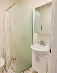 a bathroom with a sink and a shower at 5minute walk to LEGO House - n9 - garden on site in Billund