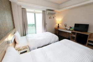 Voodi või voodid majutusasutuse Hoya Resort Hotel Chiayi toas