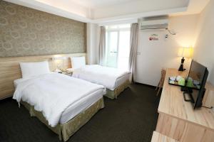 Voodi või voodid majutusasutuse Hoya Resort Hotel Chiayi toas