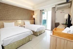 Voodi või voodid majutusasutuse Hoya Resort Hotel Chiayi toas