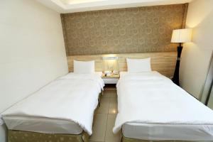 Voodi või voodid majutusasutuse Hoya Resort Hotel Chiayi toas