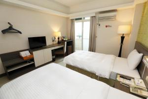 Voodi või voodid majutusasutuse Hoya Resort Hotel Chiayi toas