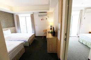 Voodi või voodid majutusasutuse Hoya Resort Hotel Chiayi toas