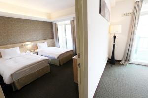 Voodi või voodid majutusasutuse Hoya Resort Hotel Chiayi toas