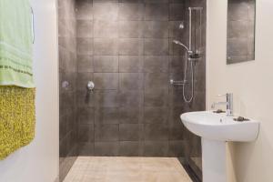 a bathroom with a shower and a sink at Mapua Wharfside Apartments in Mapua +27 photos