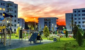 a park with a playground in a city at sunset at ForestView Dream Apartment in Bucharest