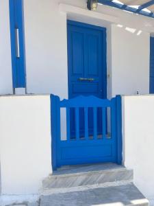 a blue door on the side of a building at Tinos Seaside Gem - Cycladic 2BR 500m from Center in Tinos Town