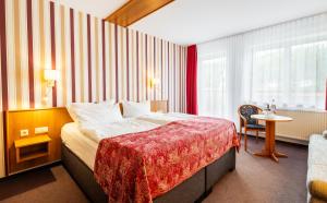 una camera d'albergo con un letto e un tavolo di Hotel Schöne Aussicht a Steinach