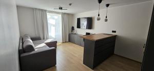 a living room with a couch and a table at Suur-Posti Apartments in Pärnu
