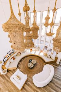 a living room with chandeliers and a table and chairs at Casa Blanca by Fieldtrip Boulder Estate with Hot Tub Soaking Pool Outdoor Shower in Yucca Valley