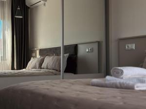 a bedroom with a bed with a large mirror at Dariq in Kazanlŭk