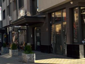 a store front with an awning on a city street at Dariq in Kazanlŭk