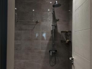 a bathroom with a shower with a glass door at Dariq in Kazanlŭk +26 photos