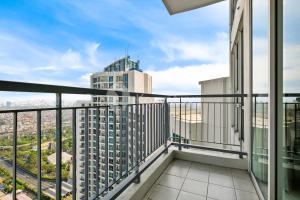 a balcony with a view of a city at Arcus by Kozystay - Ancol in Jakarta