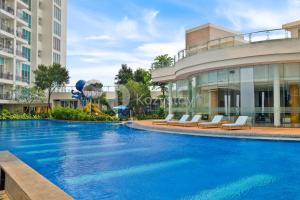 a swimming pool in front of a building at Arcus by Kozystay - Ancol in Jakarta