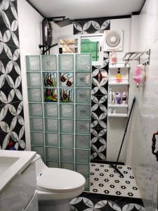 a small bathroom with a toilet and a shelf at Phala Sunshine Villa in Ban Phala