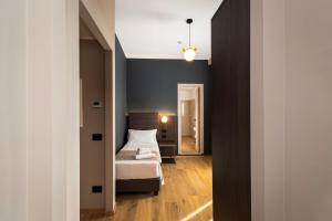 a bedroom with a bed and a hallway at Hotel San Remo in Rome