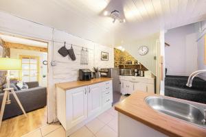 a kitchen with a sink and a counter top at Host & Stay - Batemill Cottage in Birch Vale