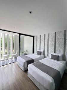 Postel nebo postele na pokoji v ubytování Nirundorn Resort Chaam