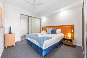 a bedroom with a large bed and a mirror at 5 Star Mandurah Beach Exclusive Apt in Mandurah +18 photos