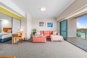 a living room with a couch and a bed at 5 Star Mandurah Beach Exclusive Apt in Mandurah