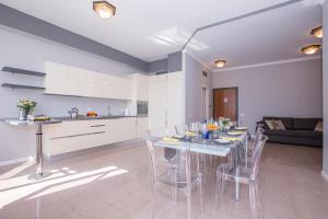 a kitchen and living room with a table and chairs at Casa Daniele in Menaggio