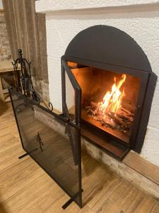 a fireplace with a fire inside of it at Casa Rural Abuelo Raimundo in Ossa de Montiel